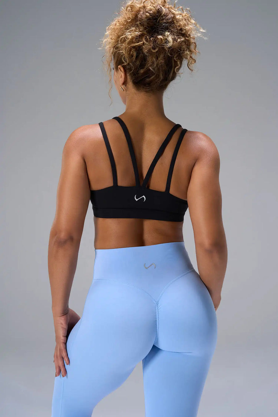 Black NeoCloud™ Strappy Sports Bra showing strappy back design and breathable cloud-soft fabric by TLF Apparel – back view