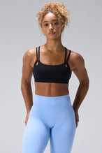 Black NeoCloud™ Strappy Sports Bra with strappy back and removable pads for everyday wear by TLF Apparel – front view