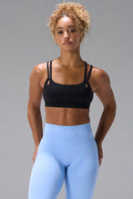 Black NeoCloud™ Strappy Sports Bra with strappy back and removable pads for everyday wear by TLF Apparel – front view
