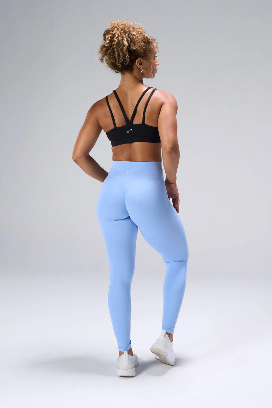 Black NeoCloud™ Strappy Sports Bra showing strappy back design and breathable cloud-soft fabric by TLF Apparel – back view