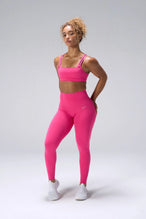 Pink NeoCloud™ Strappy Sports Bra showing side silhouette, medium support, and removable pads by TLF Apparel – front view