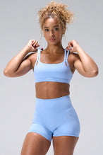 Blue NeoCloud™ Strappy Sports Bra with strappy back and removable pads for everyday wear by TLF Apparel – front view