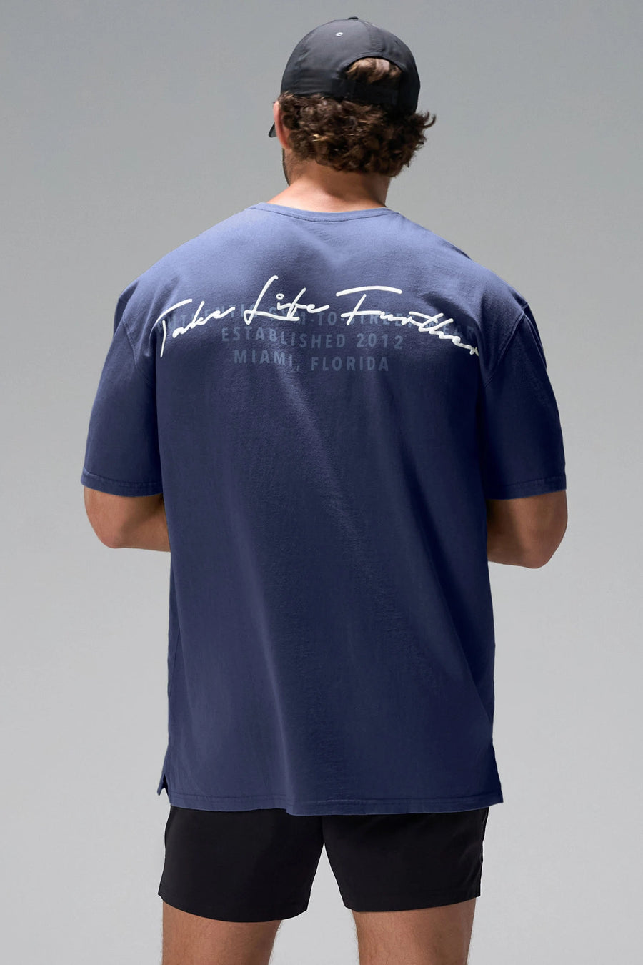 Navy Further Dura Cotton Short Sleeve Tee showing arched Take Life Further graphic and oversized fit by TLF Apparel – back view