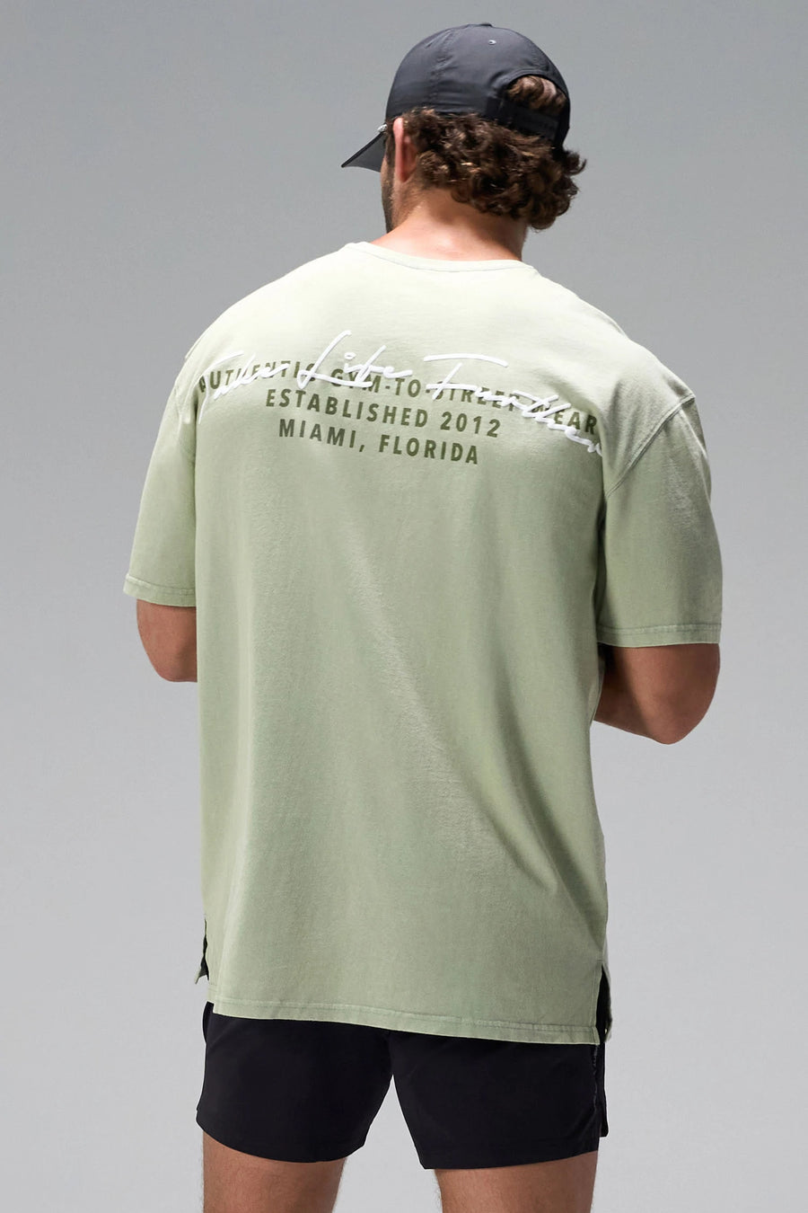 Green Further Dura Cotton Short Sleeve Tee showing arched Take Life Further graphic and oversized fit by TLF Apparel – back view