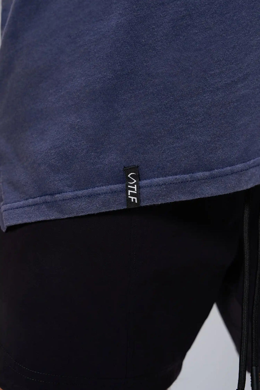 Navy RI Oversized Dura Cotton Short Sleeve Tee showing, stonewash finish, and woven hem clip label by TLF Apparel – detail view