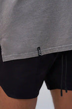 Gray RI Oversized Dura Cotton Short Sleeve Tee showing stonewash finish, and woven hem clip label by TLF Apparel – detail view
