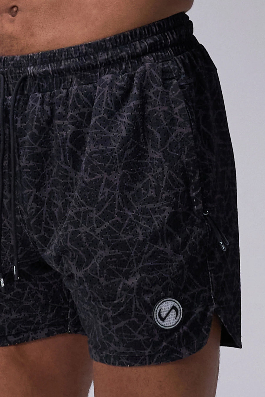 Black Splatter Print Reps Mesh 5 Inch Fitted Shorts showing athletic side silhouette, side split hems, and zip pocket storage by TLF Apparel – side view