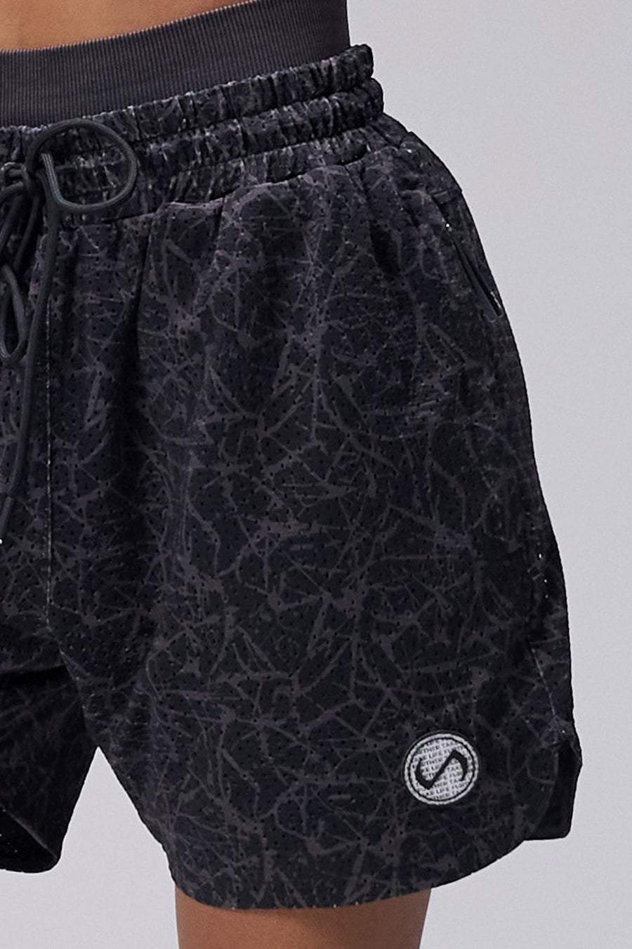Black Splatter Print Reps Mesh 5 Inch Shorts showing Mesh Tech DNA™ fabric, side split hem construction, and premium details by TLF Apparel – detail view