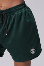 Green Reps Mesh 5 Inch Shorts showing Mesh Tech DNA™ fabric, side split hem construction, and premium details by TLF Apparel – detail view