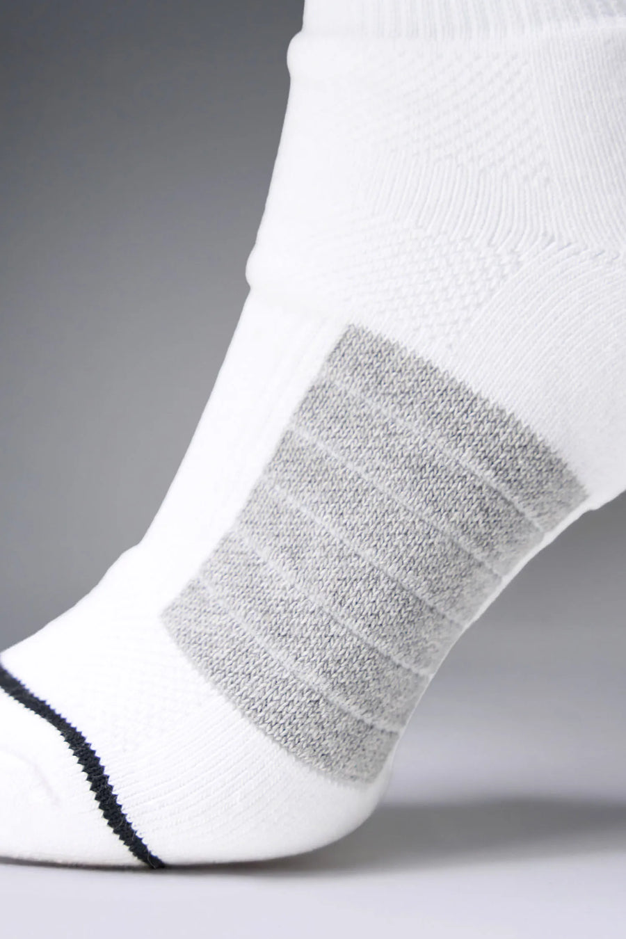 White Unisex Performance Crew Socks with medium cushioning, targeted compression, and jacquard foot mapping for support and comfort by TLF Apparel – side toe view 