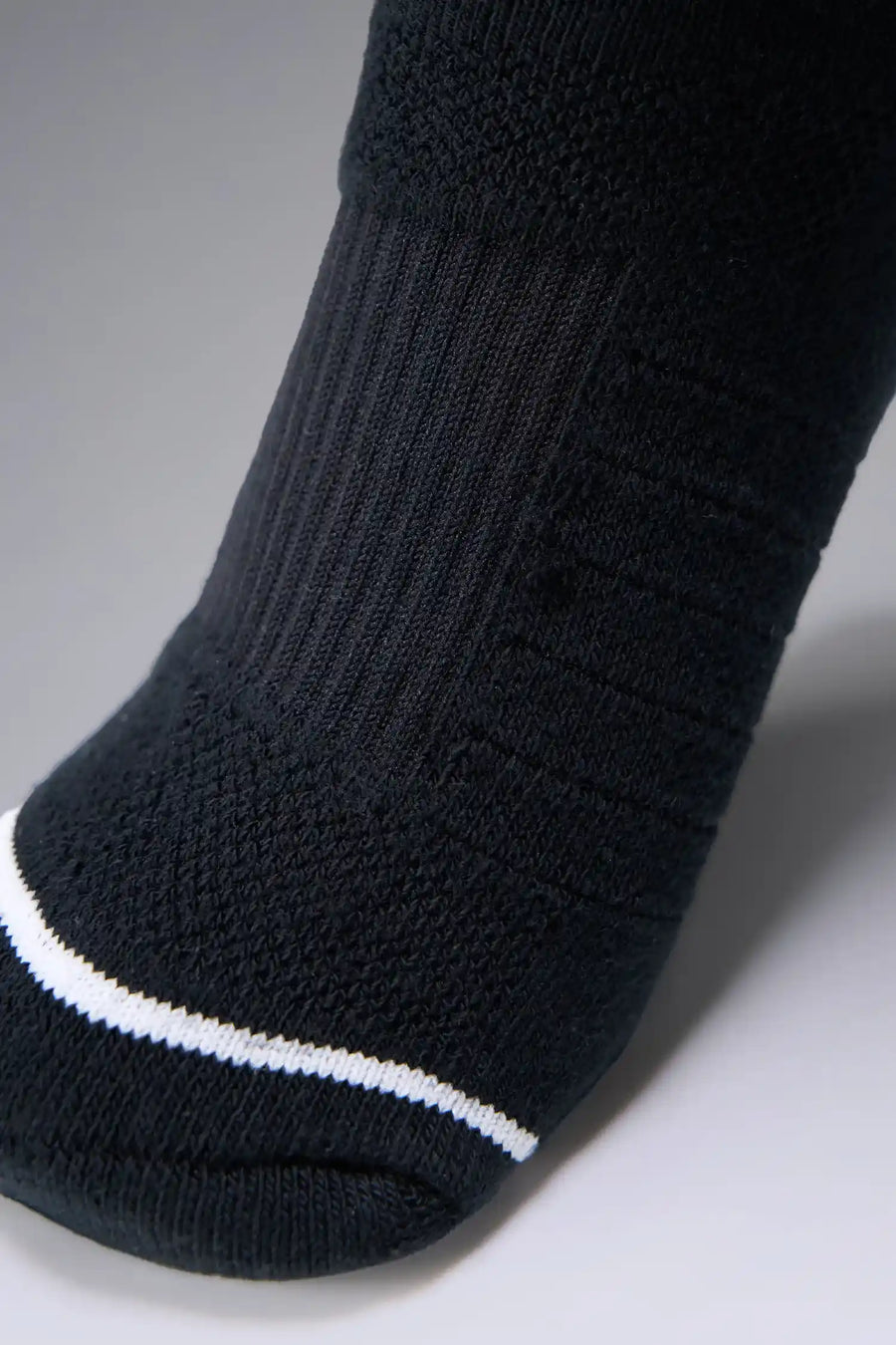 Black Unisex Performance Crew Socks with medium cushioning, targeted compression, and jacquard foot mapping for support and comfort by TLF Apparel – detail view 