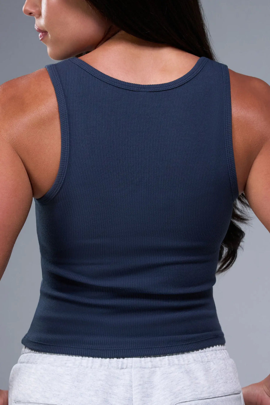 Back View of Blue TLF Essential Ribbed Tank Top, featuring a scoop neckline in our ribbed tech fabric