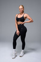 Front View of Black TLF NeoCloud™ Secret Glute Seam Leggings featuring our new secret glute seam technology to lift and shape your glutes. 