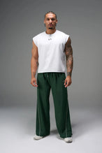 Front View of Green TLF Baggy Track Pants (Men’s GTS Gym-To-Street Edition) featuring side pockets and reflective piping details with an oversized fit 