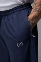 Detail View of Blue TLF Baggy Track Pants (Men’s GTS Gym-To-Street Edition) featuring side pockets and reflective piping details with an oversized fit 