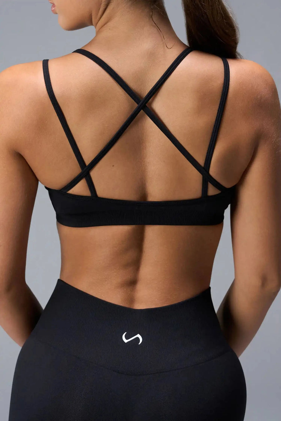 Back View of Black TLF Cosmic Seamless Strappy Sports, featuring medium impact support and a strappy back design 