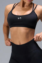 Front View of Black TLF Cosmic Seamless Strappy Sports, featuring medium impact support and a strappy back design 