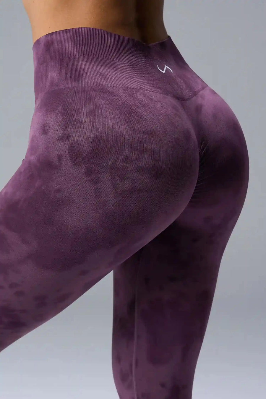 Back View of Purple TLF Cosmic Seamless Scrunch Butt Leggings, featuring a scrunch butt to shape and contour your glutes 
