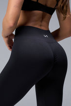 Back View of Black TLF Cosmic Seamless Scrunch Butt Leggings, featuring a scrunch butt to shape and contour your glutes 