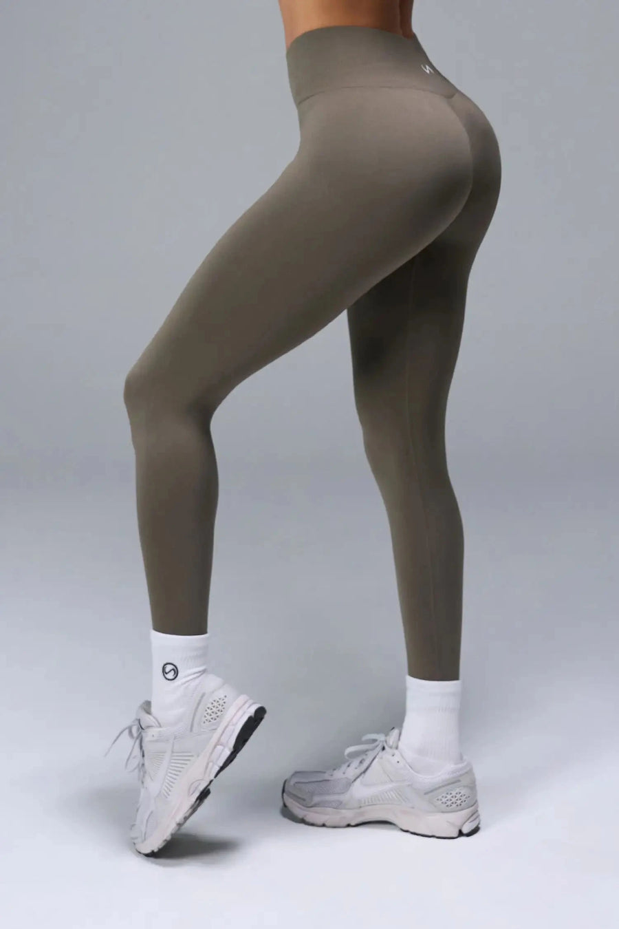 Side View of Brown TLF Cosmic Seamless Scrunch Butt Leggings, featuring a scrunch butt to shape and contour your glutes 