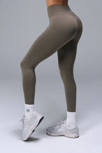 Side View of Brown TLF Cosmic Seamless Scrunch Butt Leggings, featuring a scrunch butt to shape and contour your glutes 