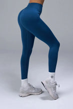 Side View of Blue TLF Cosmic Seamless Scrunch Butt Leggings, featuring a scrunch butt to shape and contour your glutes 
