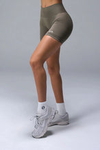 Side View of Brown TLF Cosmic Seamless Scrunch Butt Shorts, featuring a scrunch butt to shape and contour your glutes 
