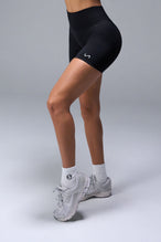 Side View of Black TLF Cosmic Seamless Scrunch Butt Shorts, featuring a scrunch butt to shape and contour your glutes 