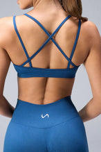 Back View of Blue TLF Cosmic Seamless Strappy Sports, featuring medium impact support and a strappy back design 