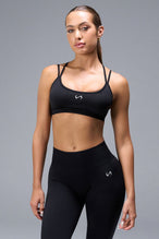 Front View of Black TLF Cosmic Seamless Strappy Sports, featuring medium impact support and a strappy back design 