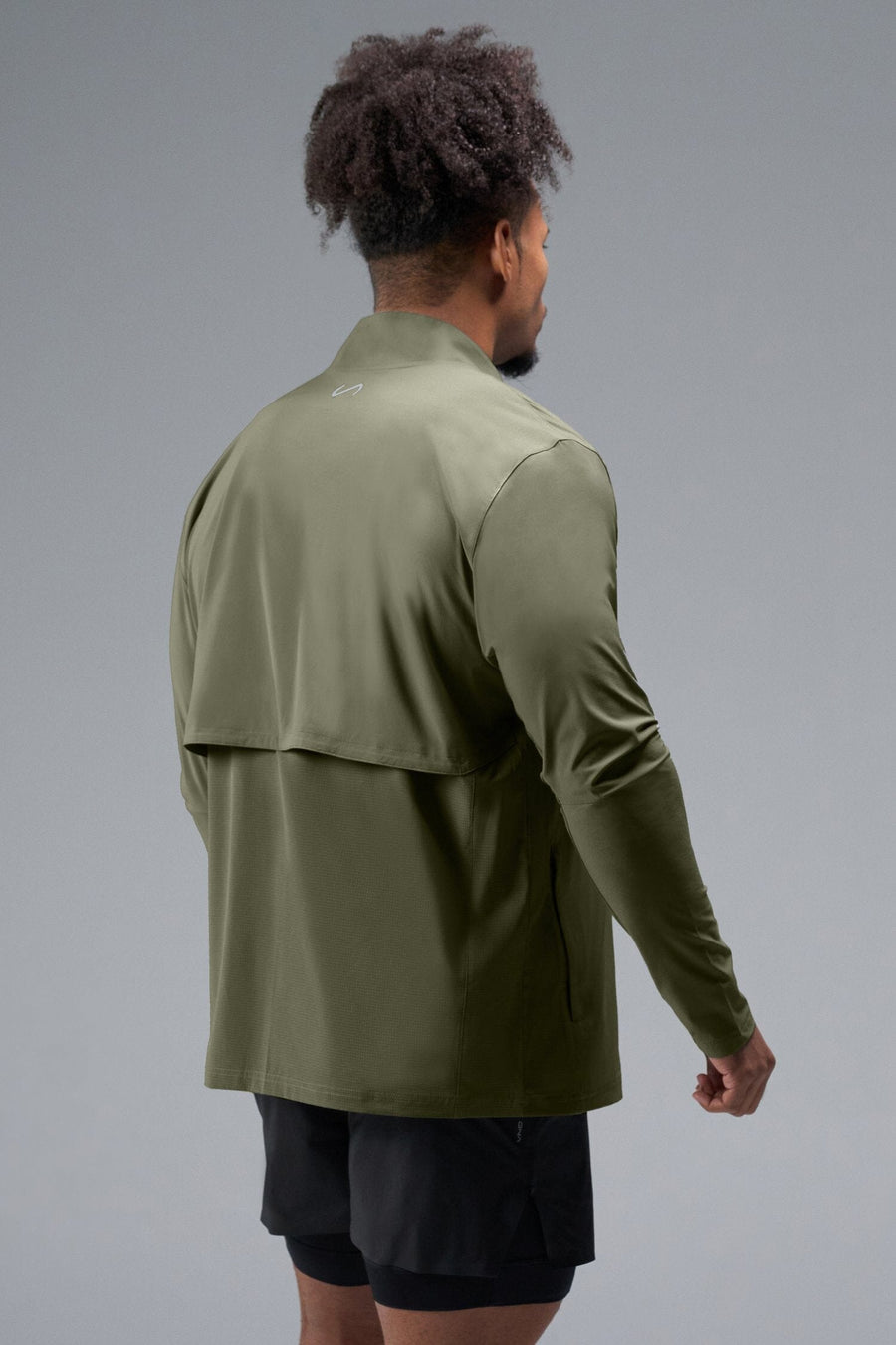 Back View of Green TLF Element Athletic Jacket, featuring multiple zipper pockets, and ripstop panels for breathability and stretch 