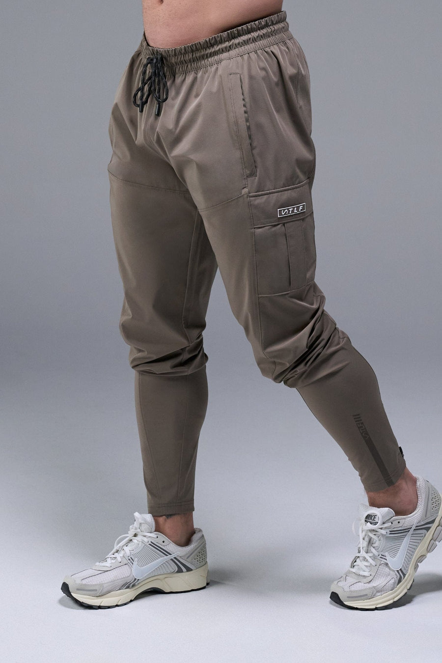 Front View of Brown TLF Element Athletic Joggers 2.0, featuring side zipper pockets and side leg cargo pockets and reflective details 
