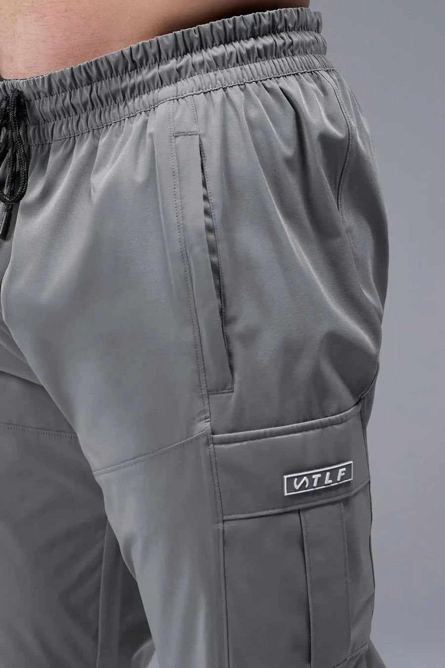 Detail View of Gray TLF Element Athletic Joggers 2.0, featuring side zipper pockets and side leg cargo pockets and reflective details 