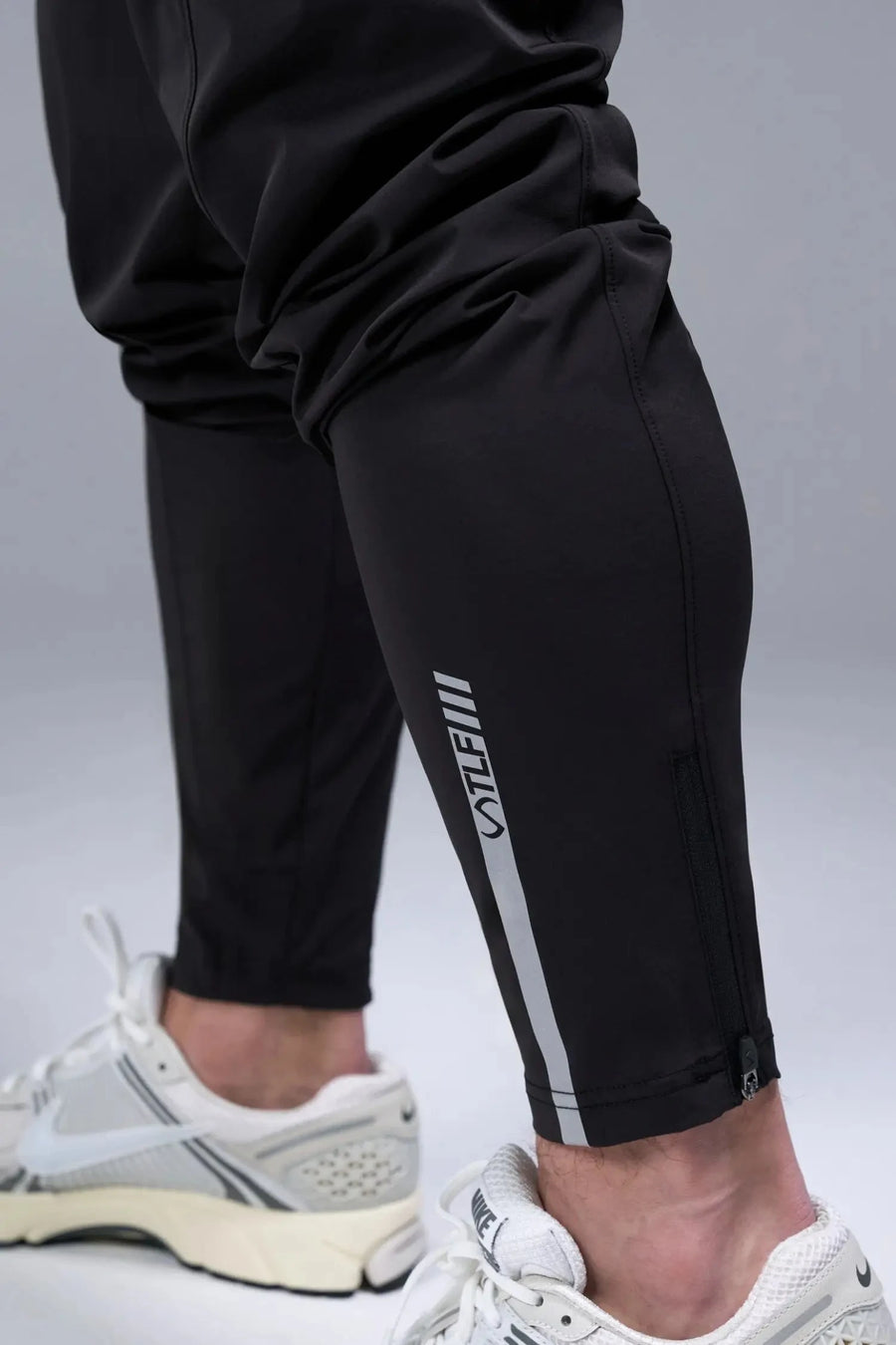 Detail Back View of Black TLF Element Athletic Joggers 2.0, featuring side zipper pockets and side leg cargo pockets and reflective details 