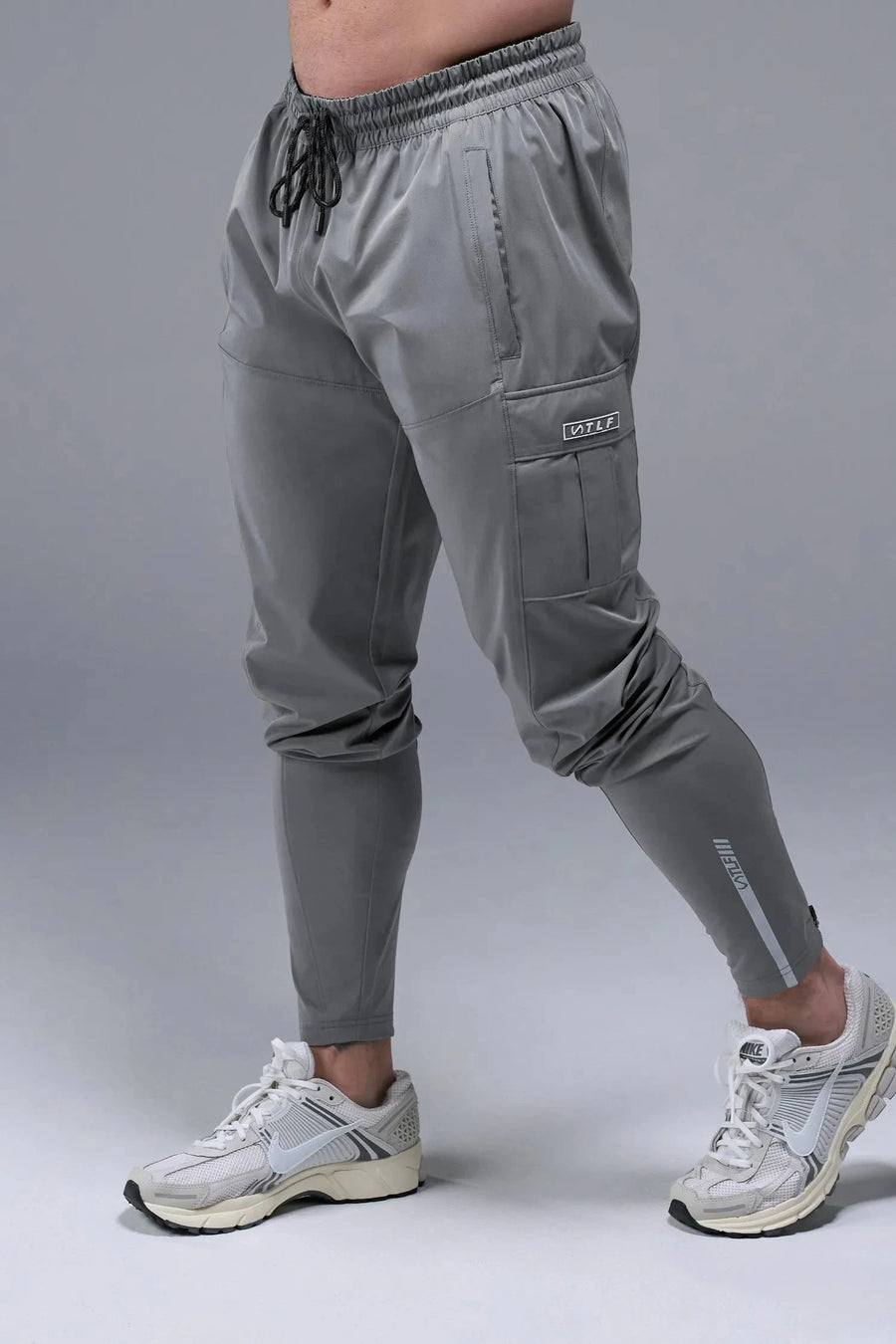 Front View of Gray TLF Element Athletic Joggers 2.0, featuring side zipper pockets and side leg cargo pockets and reflective details 