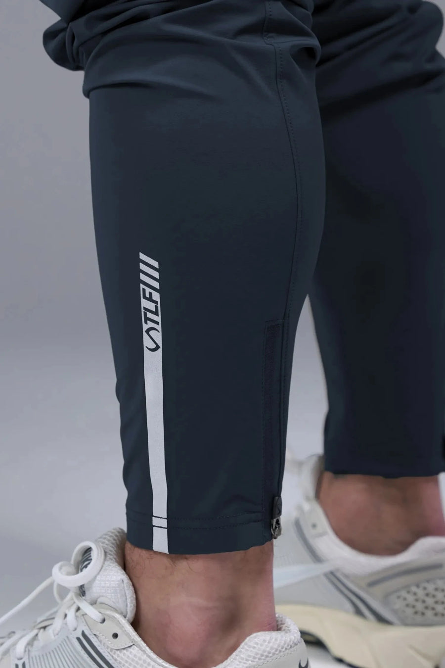 Detail Back View of Blue TLF Element Athletic Joggers 2.0, featuring side zipper pockets and side leg cargo pockets and reflective details 