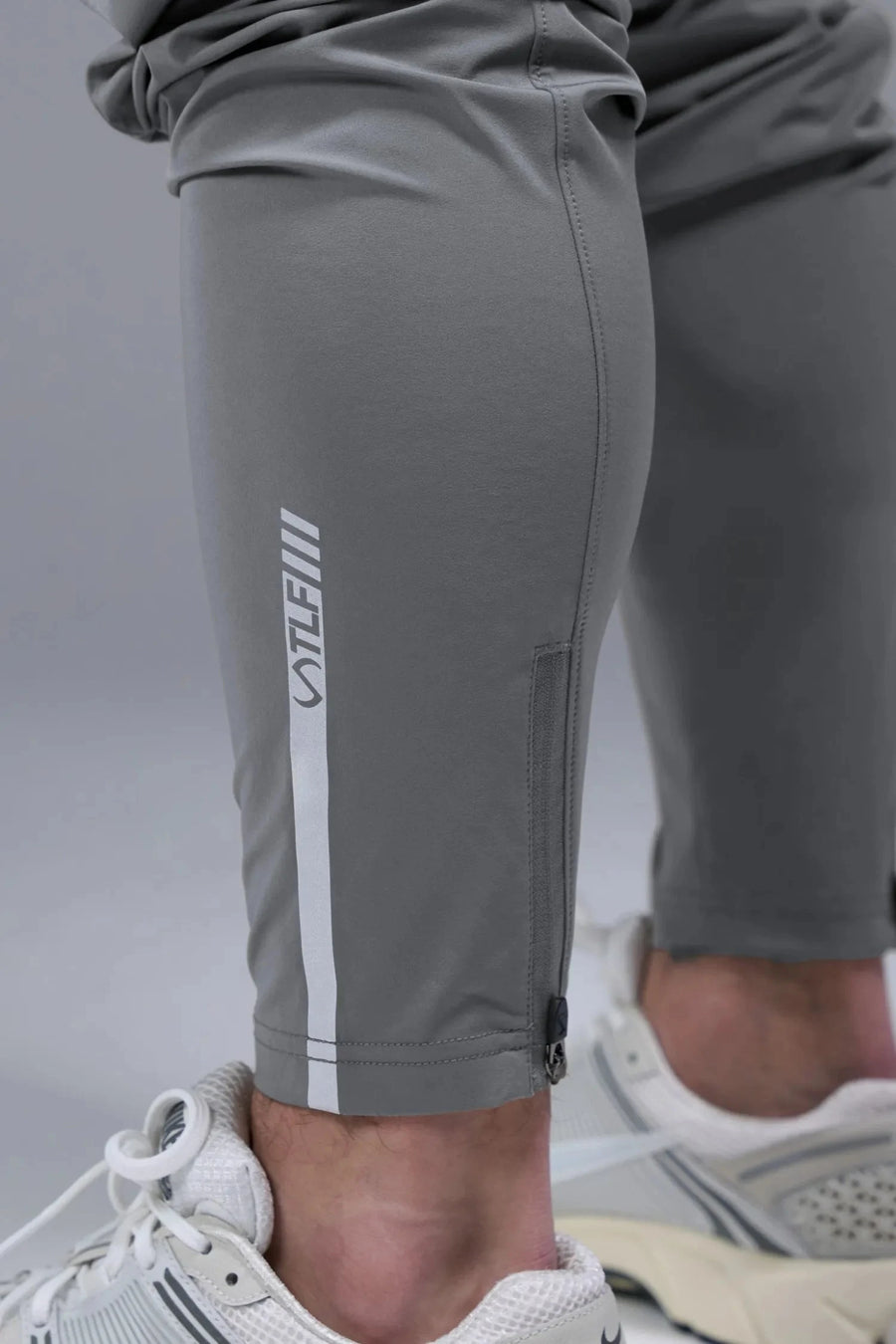 Detail Back View of Gray TLF Element Athletic Joggers 2.0, featuring side zipper pockets and side leg cargo pockets and reflective details 