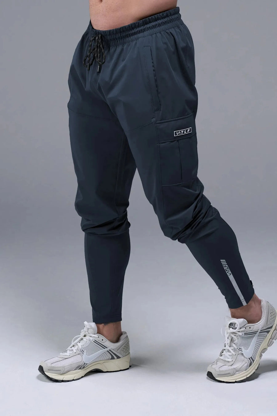 Front View of Blue TLF Element Athletic Joggers 2.0, featuring side zipper pockets and side leg cargo pockets and reflective details 
