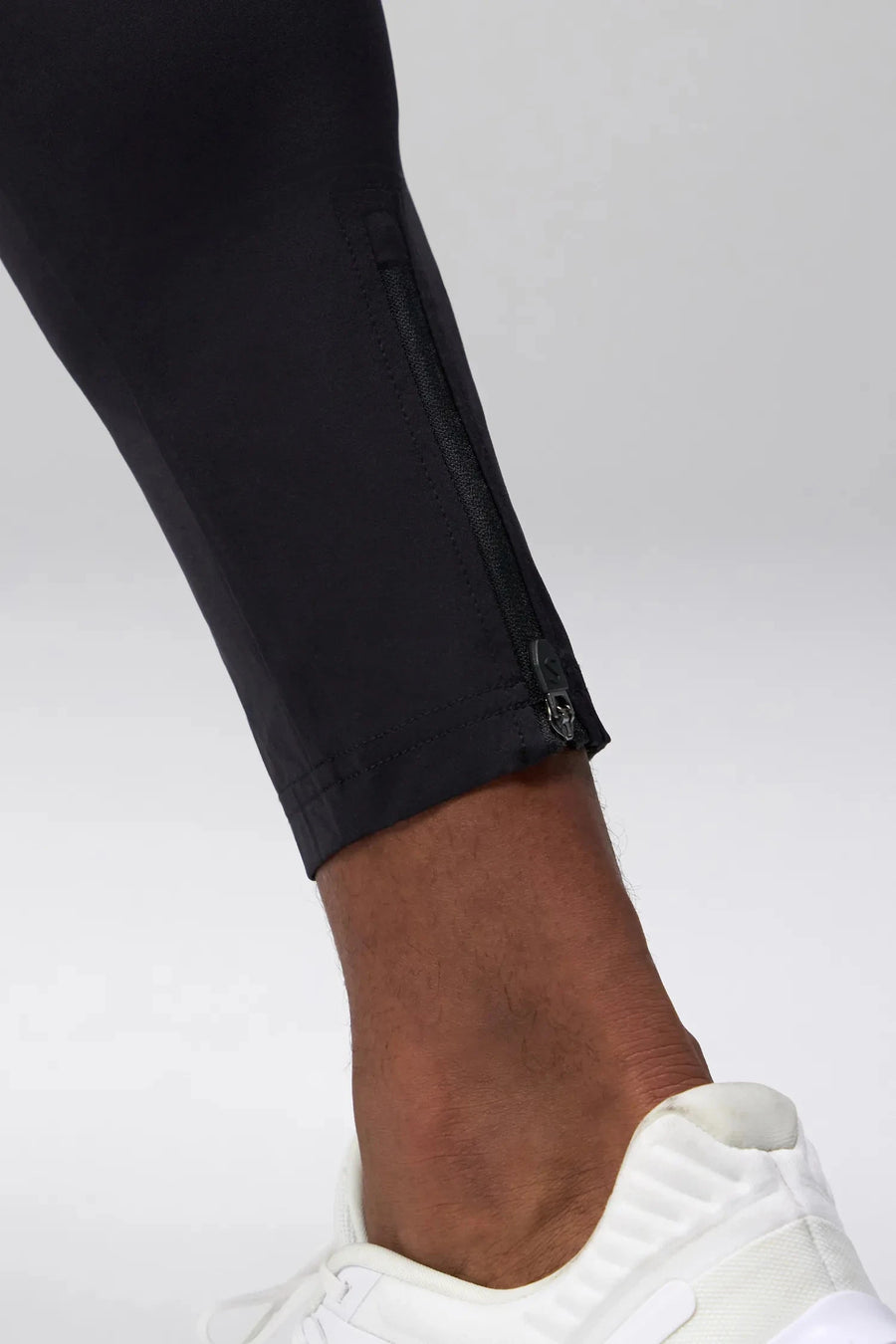 Detail View of Black the TLF Element Infi-Dry Hybrid Joggers featuring side zipper pockets, zippered ankles and drawcord waistband for a custom fit. 