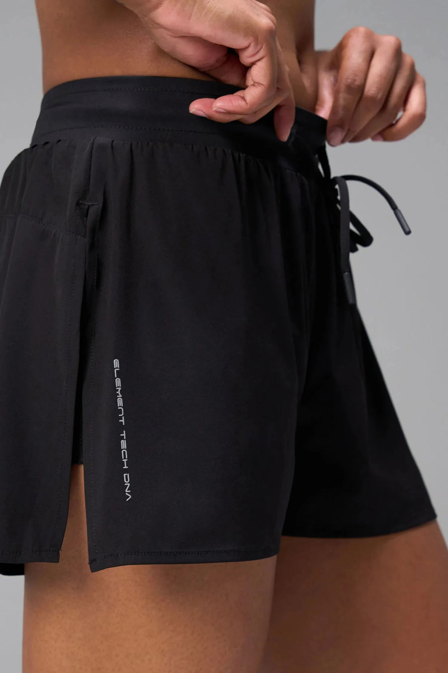 Side View of the Black the TLF Element Infi Dry Shorts With Liner featuring built in shorts with pockets and high side slit for mobility