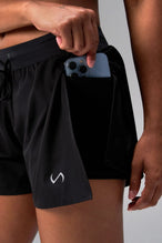 Detail Front View of the Black the TLF Element Infi Dry Shorts With Liner featuring built in shorts with pockets and high side slit for mobility