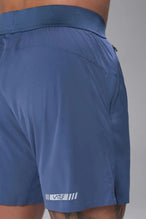 Back View of the Blue the TLF Element Light 7 Inch Shorts featuring side zipper pockets, side split hems and reflective details for nighttime visibility. 
