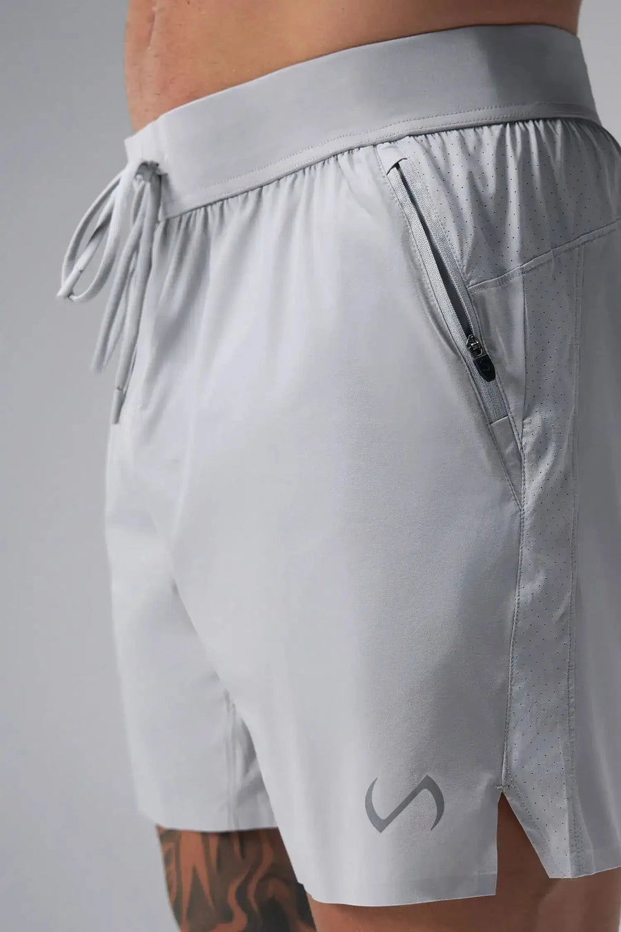 Side View of the Gray the TLF Element Light 7 Inch Shorts featuring side zipper pockets, side split hems and reflective details for nighttime visibility. 