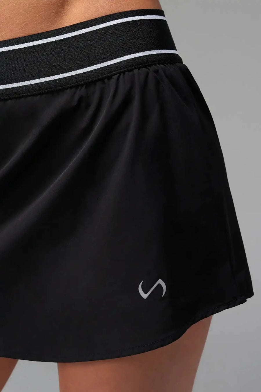 Front View of Black TLF Element workout skirt featuring built in 2.5-inch inseam shorts and side pockets