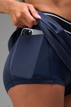 Side View of Blue TLF Element workout skirt featuring built in 2.5-inch inseam shorts and side pockets