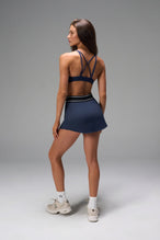Back View of Blue TLF Element workout skirt featuring built in 2.5-inch inseam shorts and side pockets