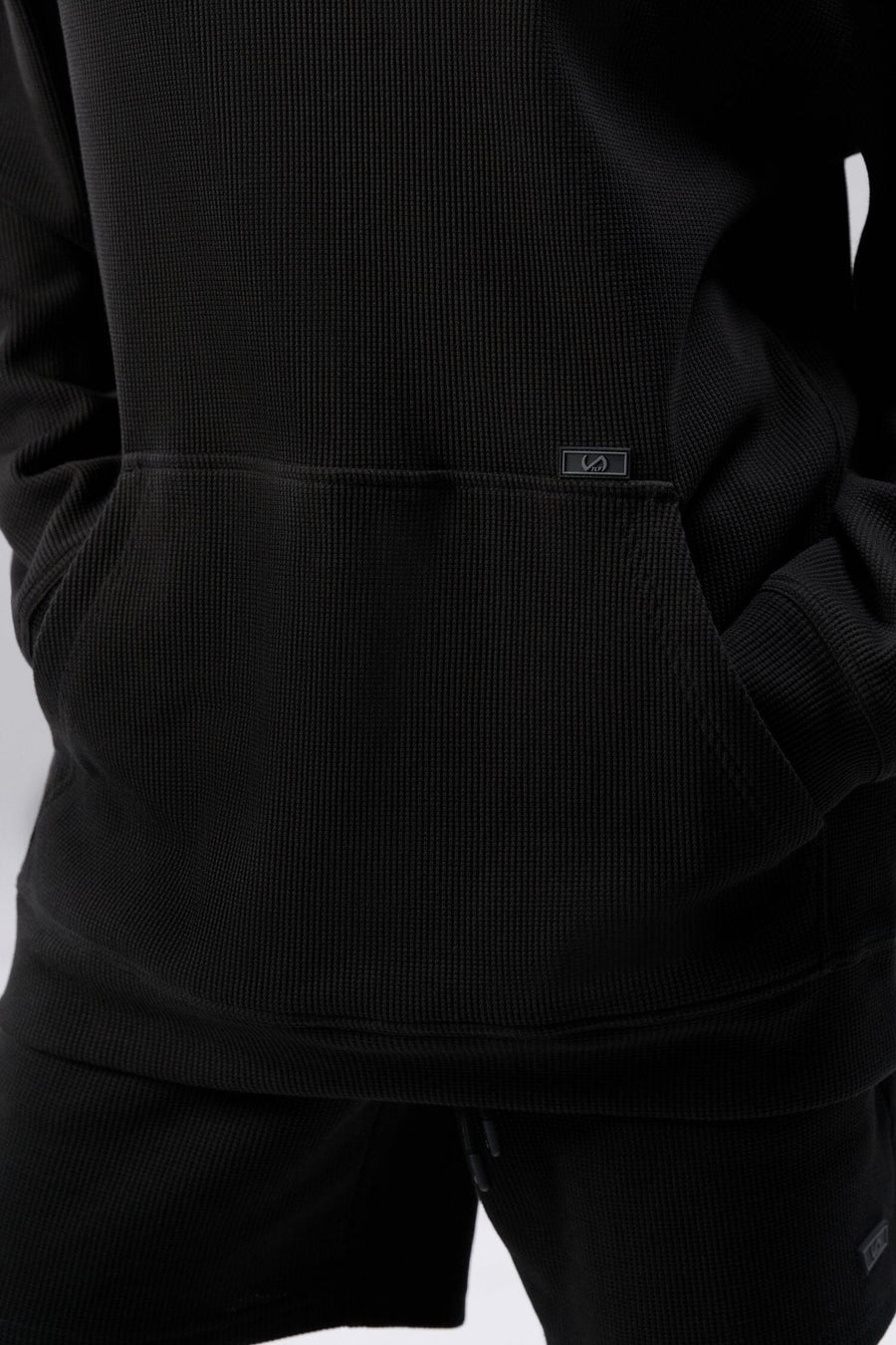 Detail Front View of Black TLF Elevate Waffle Tech Hoodie, featuring kangaroo pockets, and double panel hoodie designed for all day wear