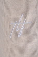 Detai View of White TLF Elevate Waffle Tech Joggers, featuring an athletic relaxed fit with zipper pockets designed for all day wear