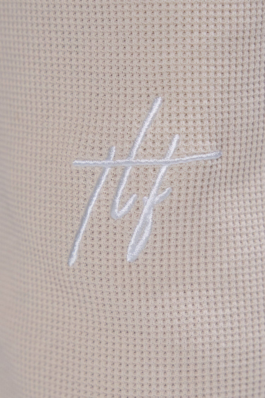 Detai View of White TLF Elevate Waffle Tech Joggers, featuring an athletic relaxed fit with zipper pockets designed for all day wear