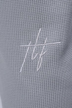 Detail Back View of Gray TLF Elevate Waffle Tech Joggers, featuring an athletic relaxed fit with zipper pockets designed for all day wear